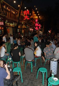 Locals sitting and eating sunflower seeds outside one of the many restaurants on Dongzhimen Inner street.
