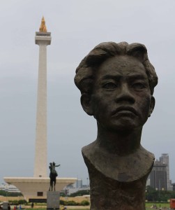 Bust of Chairil Anwar, an Indonesian poet from the "1945 generation" of writers, with Monas in the background.