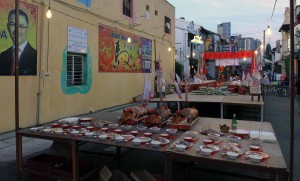A Buddhist ceremonial dinner with many gifts of food set up for tonight - possibly for a deceased person.