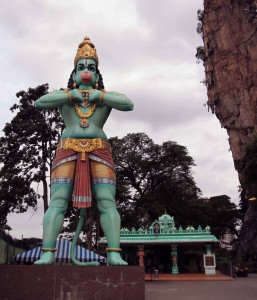 Hanuman, the noble monkey devotee and aide of Lord Rama, with temple behind him.