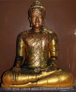 A smaller Buddha statue covered in metallic leaf inside Wat Phra Mongkhon Bophit.