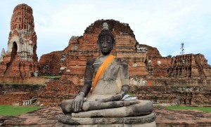 Buddha statue seated in front of where the principle prang once stood in Wat Maha That.