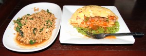 Minced chicken with holy basil and garlic on the left and a half-eaten Thai-style omelette on the right.