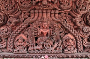 Intricate wood carving above a doorway.