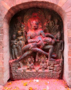 Hindu sculpture covered in red dye.