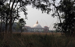 A modern Buddhist temple seen in the distance.