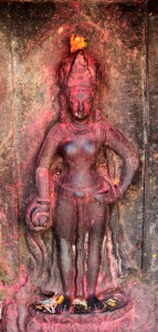 Statue nearly covered in red dye at Pashupatinath.