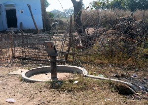 Water pump that looks like a linga and yoni sculpture.