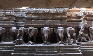 Elephant sculptures lined up alongside the main structure in the Kailasa Cave temple.