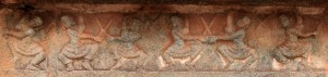 Relief depicting men engaged in sword fighting.