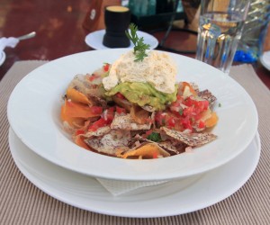 "Kachos", Kenyan-style nachos made with fried arrowroot, cassava and potato chips with melted cheese, guacamole, tomato salsa, chili peppers, sour cream, and coriander. 