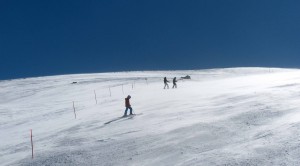 Skiers pushing against the wind.