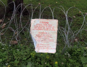Sign warning of the danger of possible unexploded bombs.