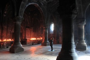 Woman praying in the center of the Katoghikeh Gavit in Geghard Monastery.