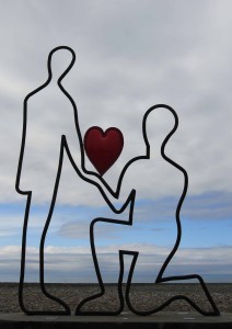 Romantic sculpture on display next to the beach.