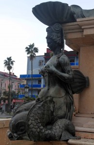 Closeup of one of the mermaid sculptures spraying water out of her nipples, on the Fountain of Neptune.