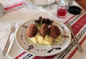 Traditional Romanian meatballs on a bed of mashed potatoes.