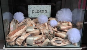 Pile of used ballet shoes in a shop window in Belgrade.