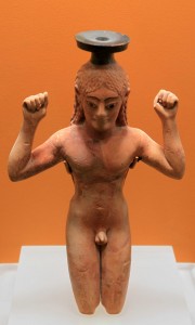 Perfume bottle in the form of a kneeling athlete binding a ribbon about his head as a symbol of victory (circa 540 BC).
