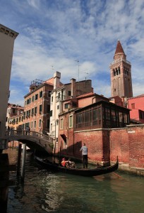 A gondola traveling down a canal.