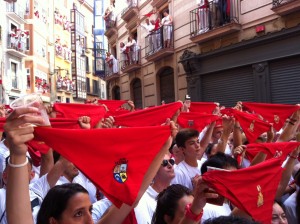 Everyone holding out their red kerchiefs and singing just before putting them around their necks (to symbolize the martyrdom of Saint Fermin - he was beheaded) for the opening ceremony.
