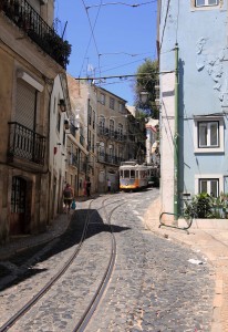 Tram 28 (Lisbon's historic and iconic tram) coming down the road.