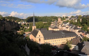 A view of the Alzette River with the casemates in the rock face on the left and Neumünster Abbey on the right.