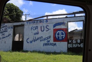 "Thank God for U.S." and "KGB Behave" graffiti on the ruins of a building - referring to the 1983 United States–led invasion; the citizens of Grenada are genuinely thankful for the U.S.'s military action (making them somewhat unique in the world).