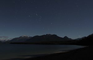 Lake Manapouri at night with the constellation Orion (seen upturned in the Southern Hemisphere).