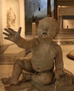Creepy looking Roman statue of a toddler.