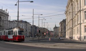 Street in Vienna with a cable car passing by.