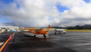 The Cessna 206 (painted yellow) that would serve as my air taxi for the day (seen here at Bauerfield International Airport in Port Vila).