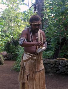 Our guide at Ekasup Cultural Village demonstrating how a banana is scraped on a piece of coral; the scrapings are then dried and preserved for emergency use.