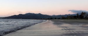 Wailoaloa Beach at sunset, with the Sleeping Giant Mountain in the distance.